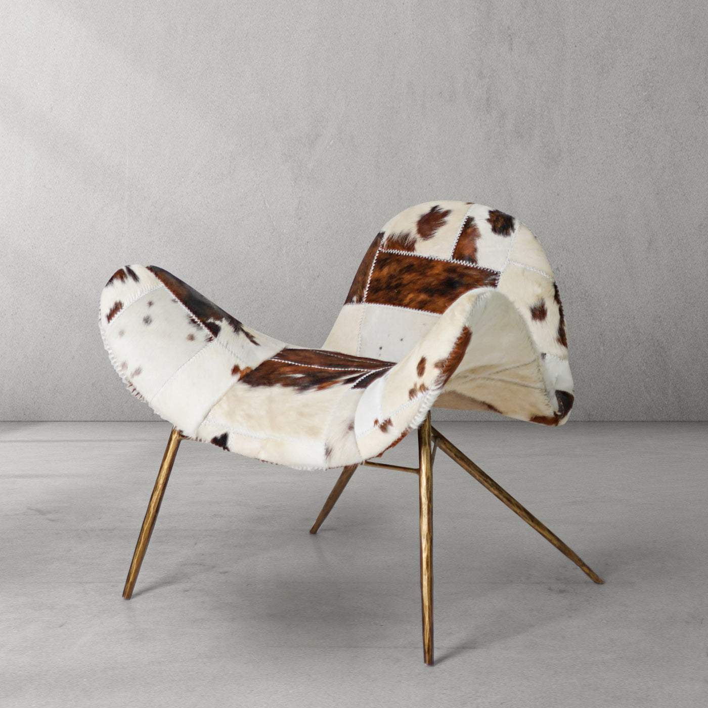 Cowhide Patchwork Wing Chair with Brass Base